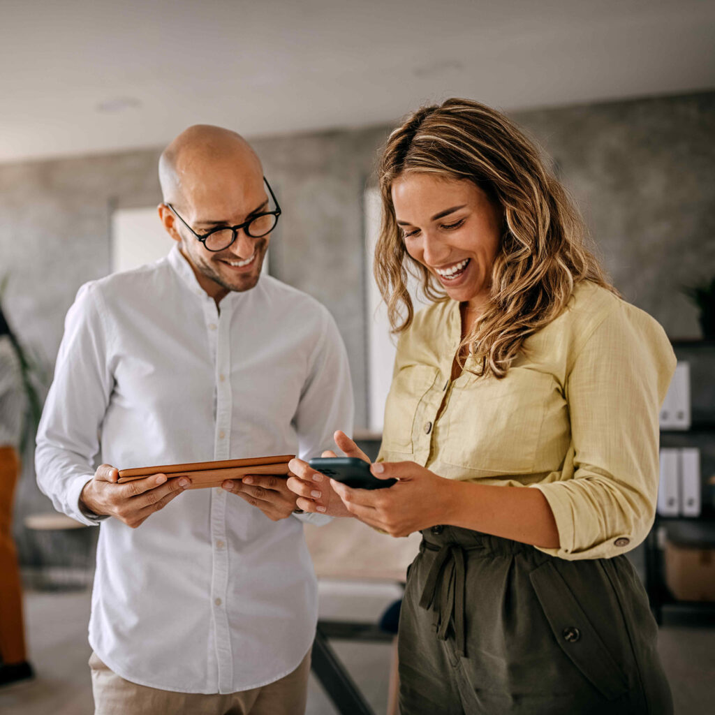 Person showing information on their phone to another person.