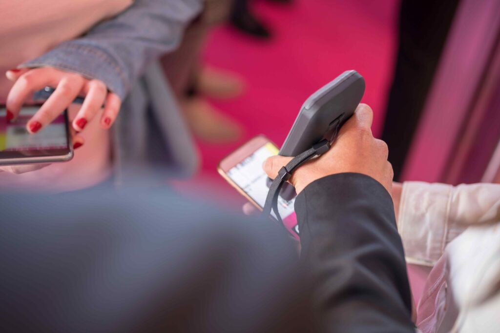 Gate attendant scanning an electronic ticket on a phone.