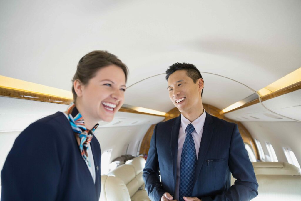 Flight attendants serving on a private jet.