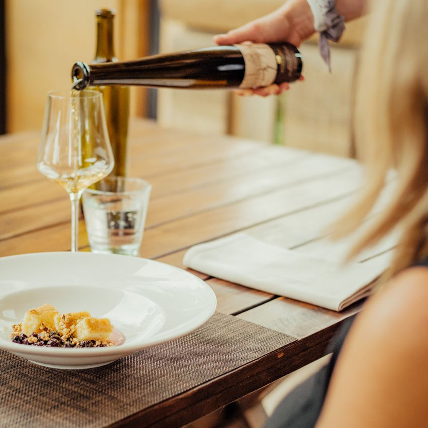 Sommelier serving a pairing with a fine dessert.