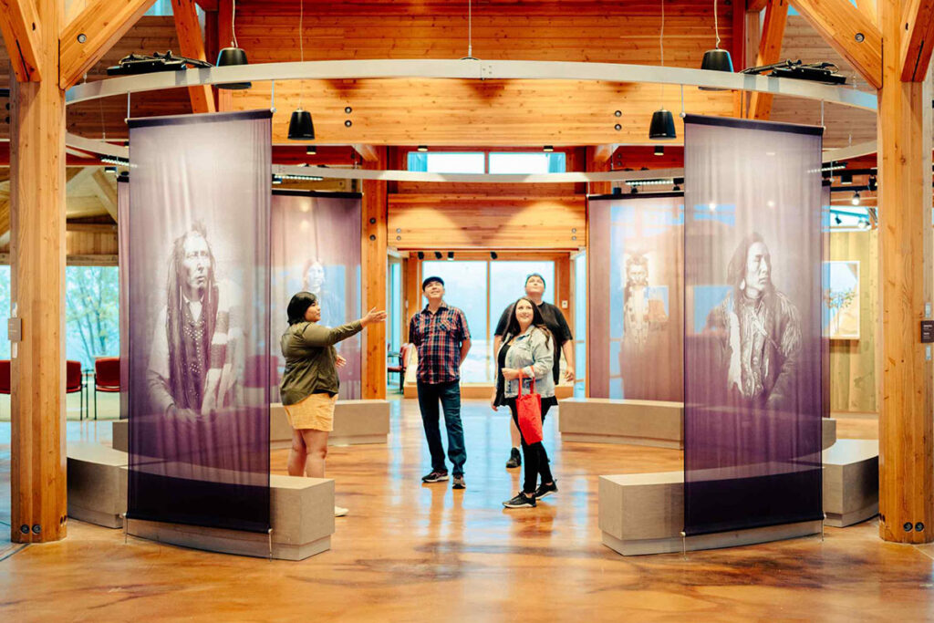 Group of people admiring an Indigenous exhibition.