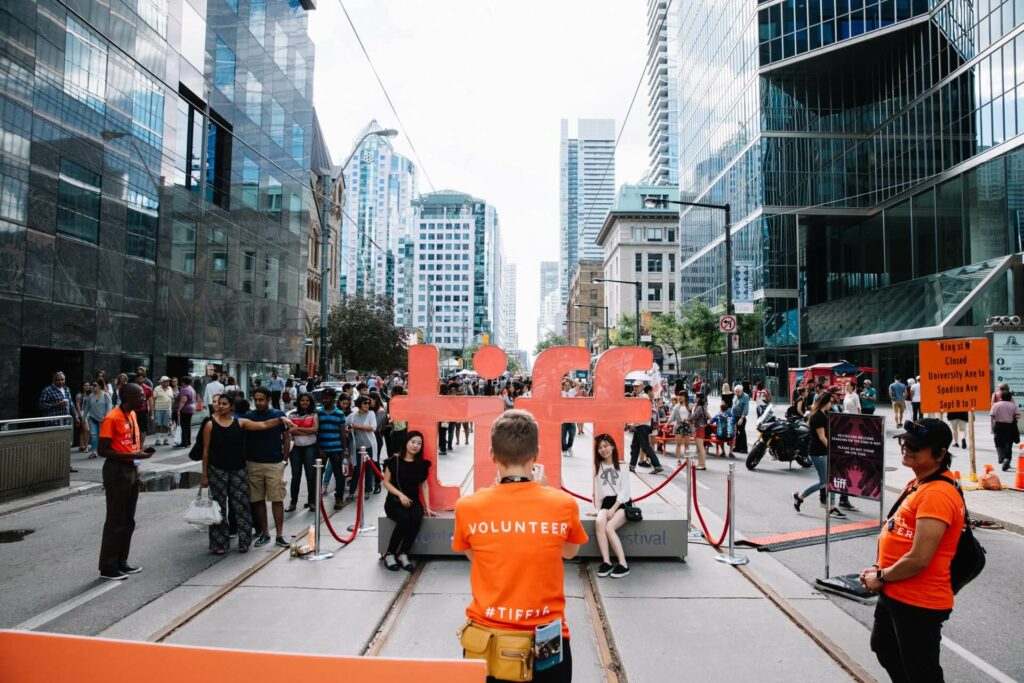 Volunteer coordinator overseeing an outdoor event at the Toronto International Film Festival.